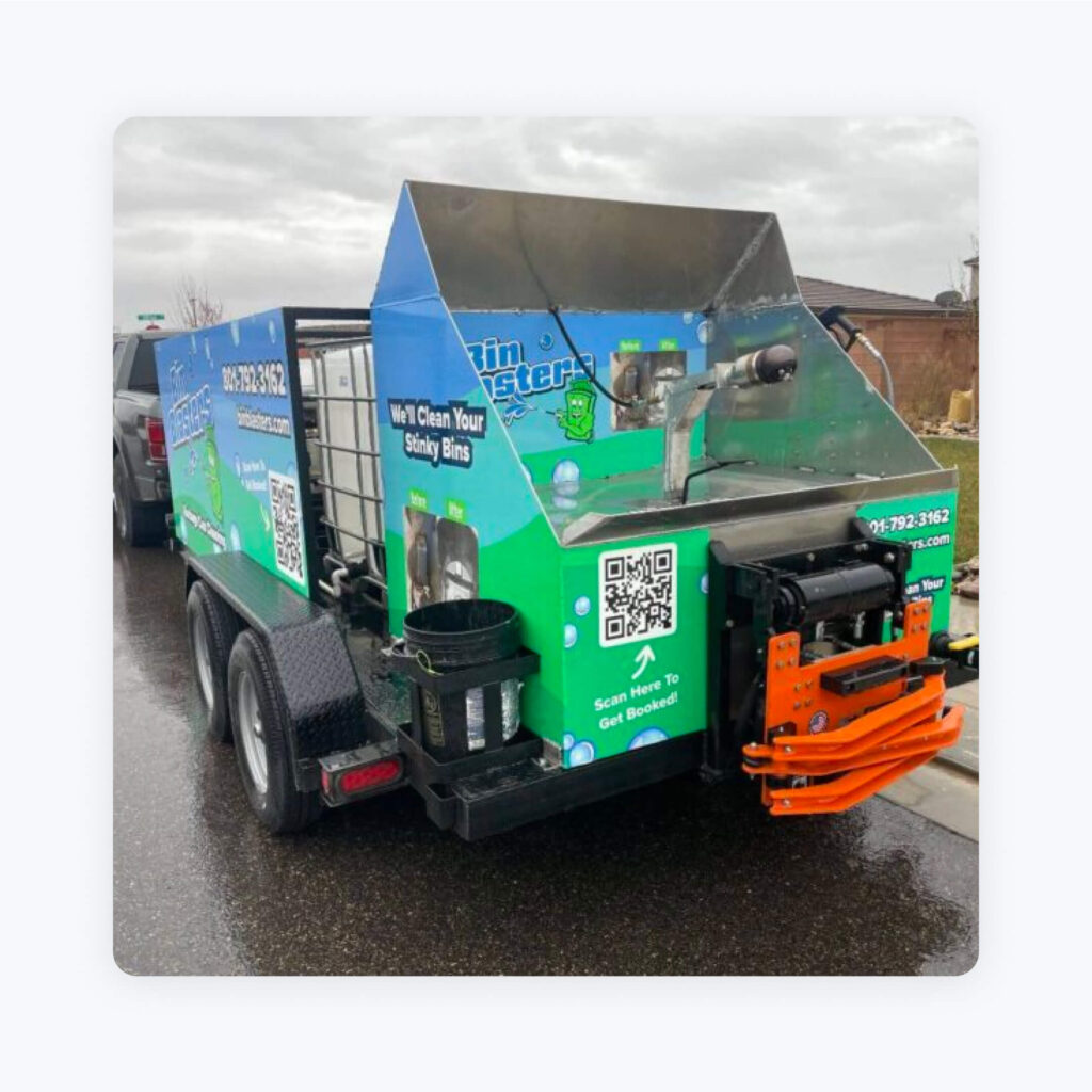 Bin Blasters' cleaning trucks, which feature their phone number on the back.