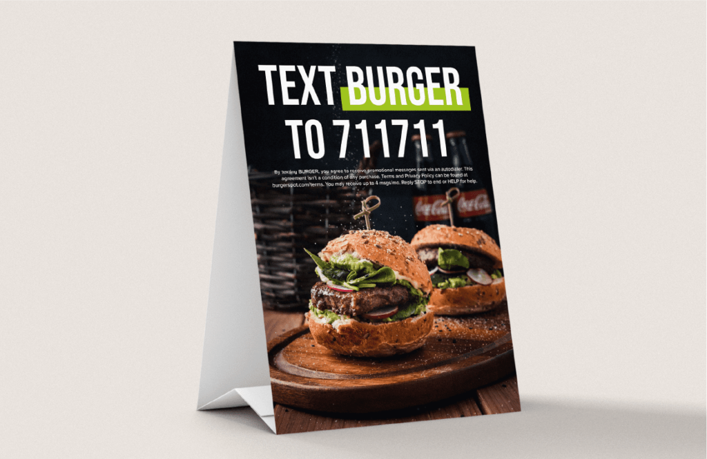 A restaurant table standee telling the viewer to text a keyword to a number